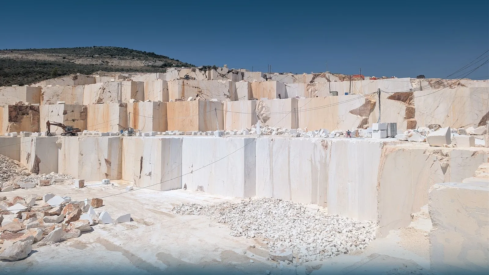 Sawn benches at the Adriakamen quarry in Plano under a clear sky
